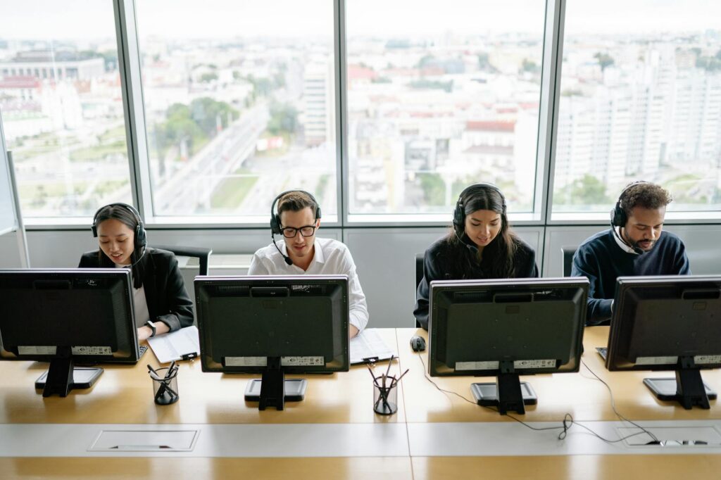 Team of diverse colleagues working efficiently at a modern call center.